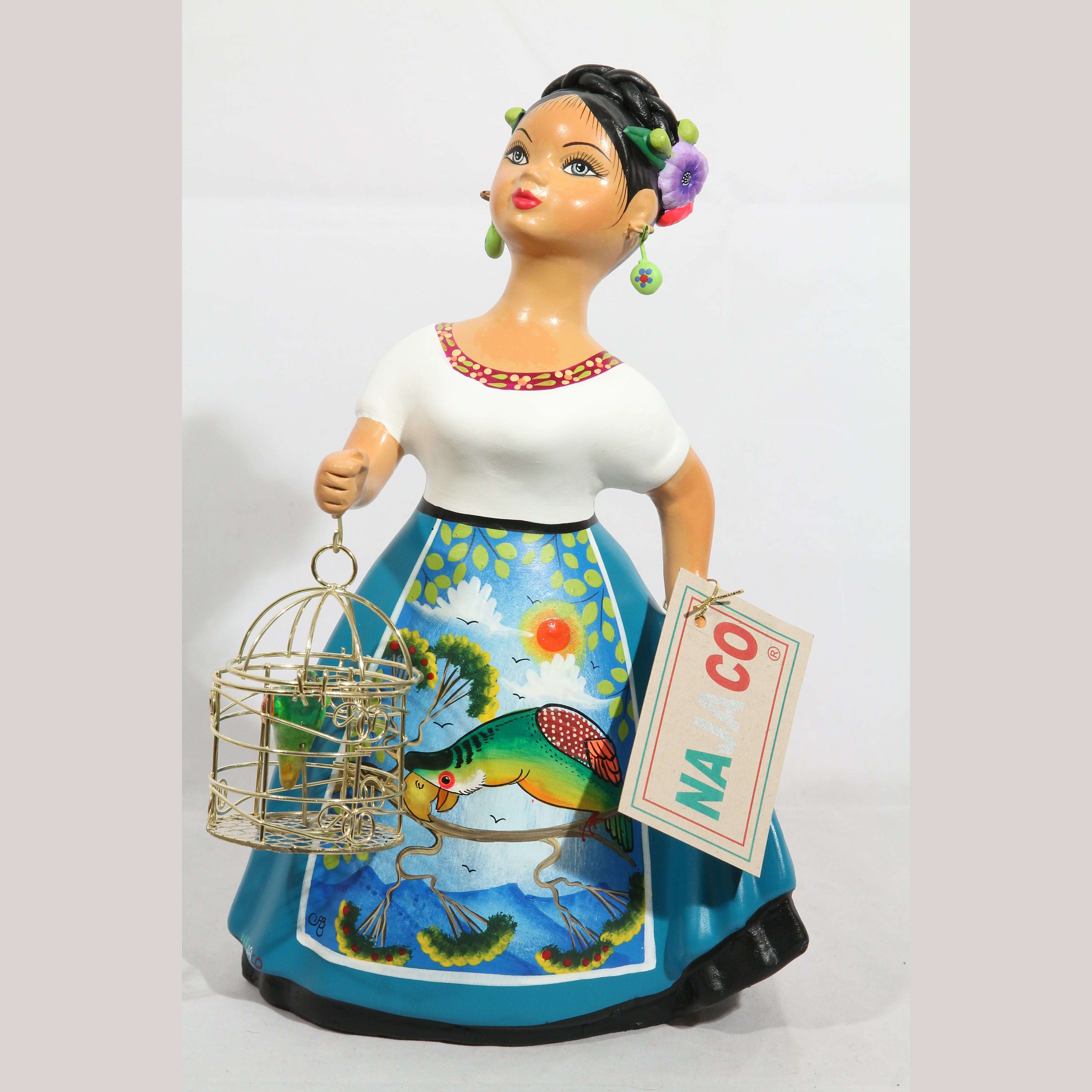 Lupita Doll holding a Parrot in a Cage. – POCHTECA